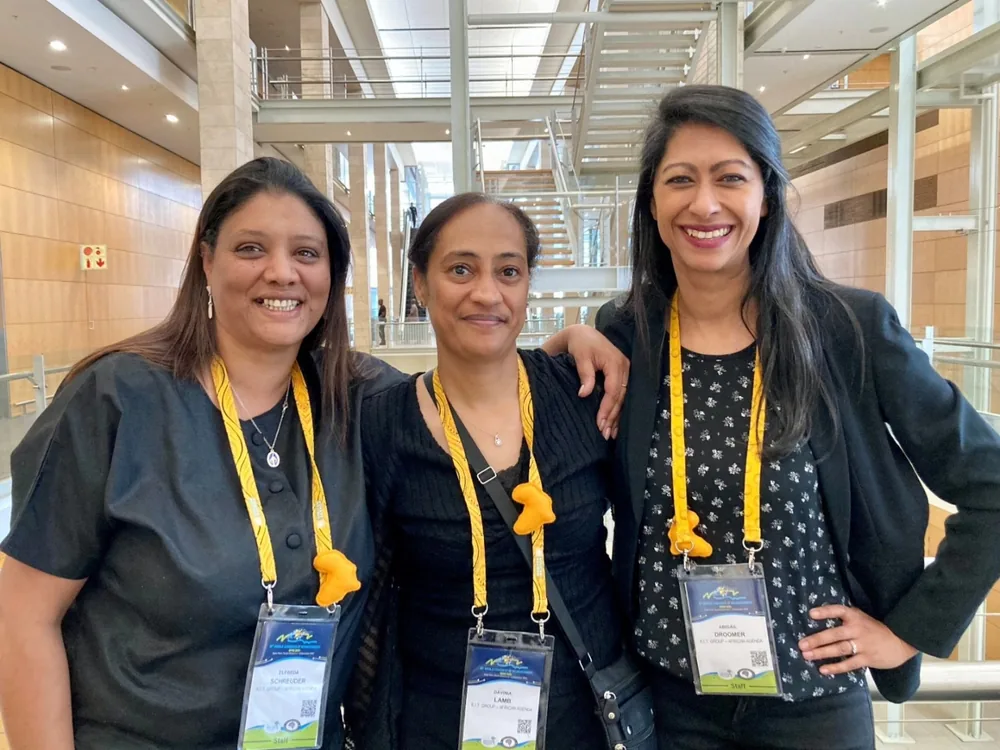 Conference staff wearing handmade yellow shweshwe double-clip lanyards with badge holders at a congress