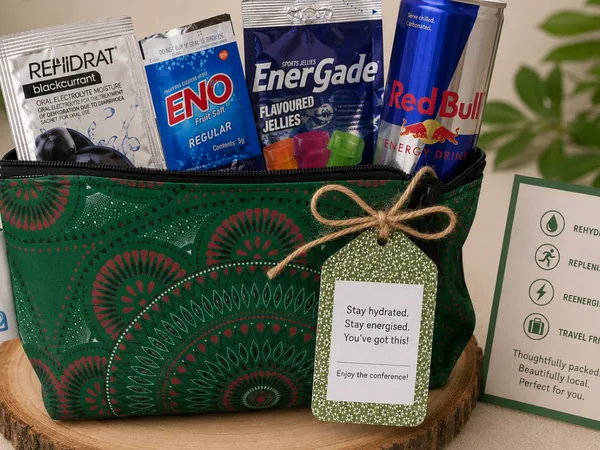 Conference rehydration kit packed in a green shweshwe pouch with a handwritten gift tag