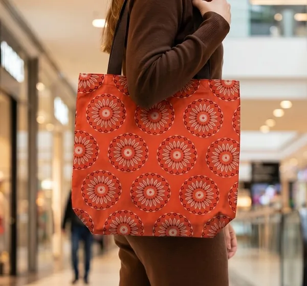 Tangerine ankara print tote bag carried over the shoulder